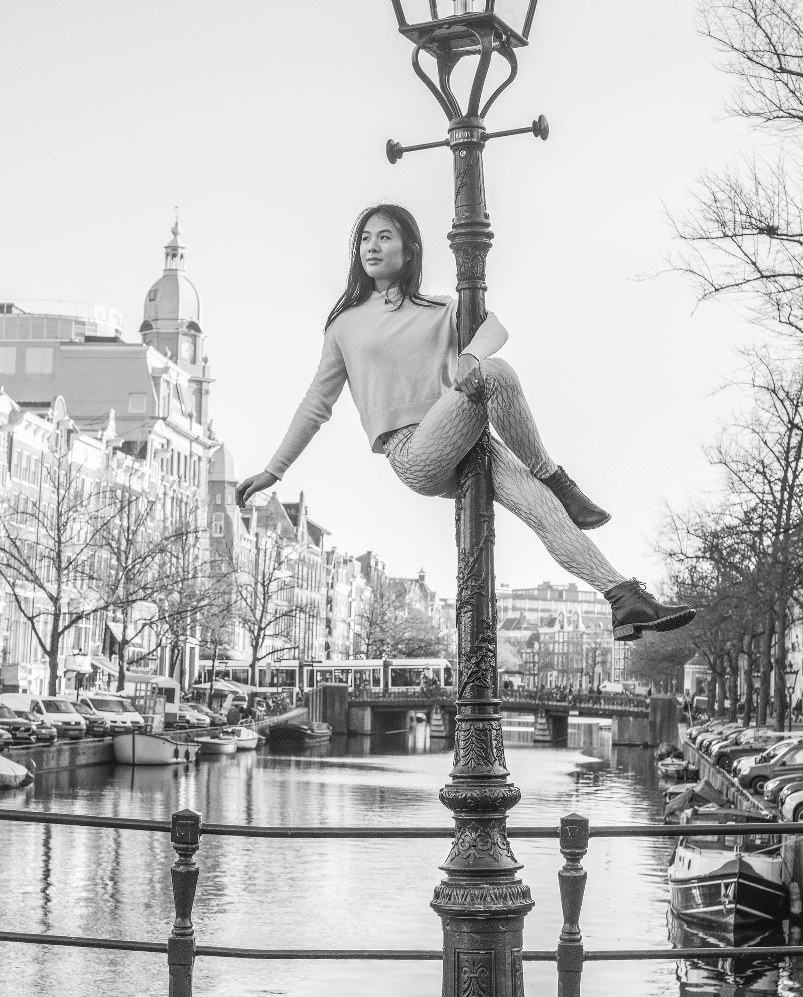 Pole dancer on a street lamp wearing sticky leggings