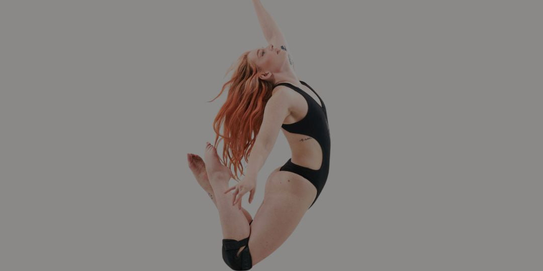 pole dancer in sticky pole wear knee pads and pole wear bodysuit in black